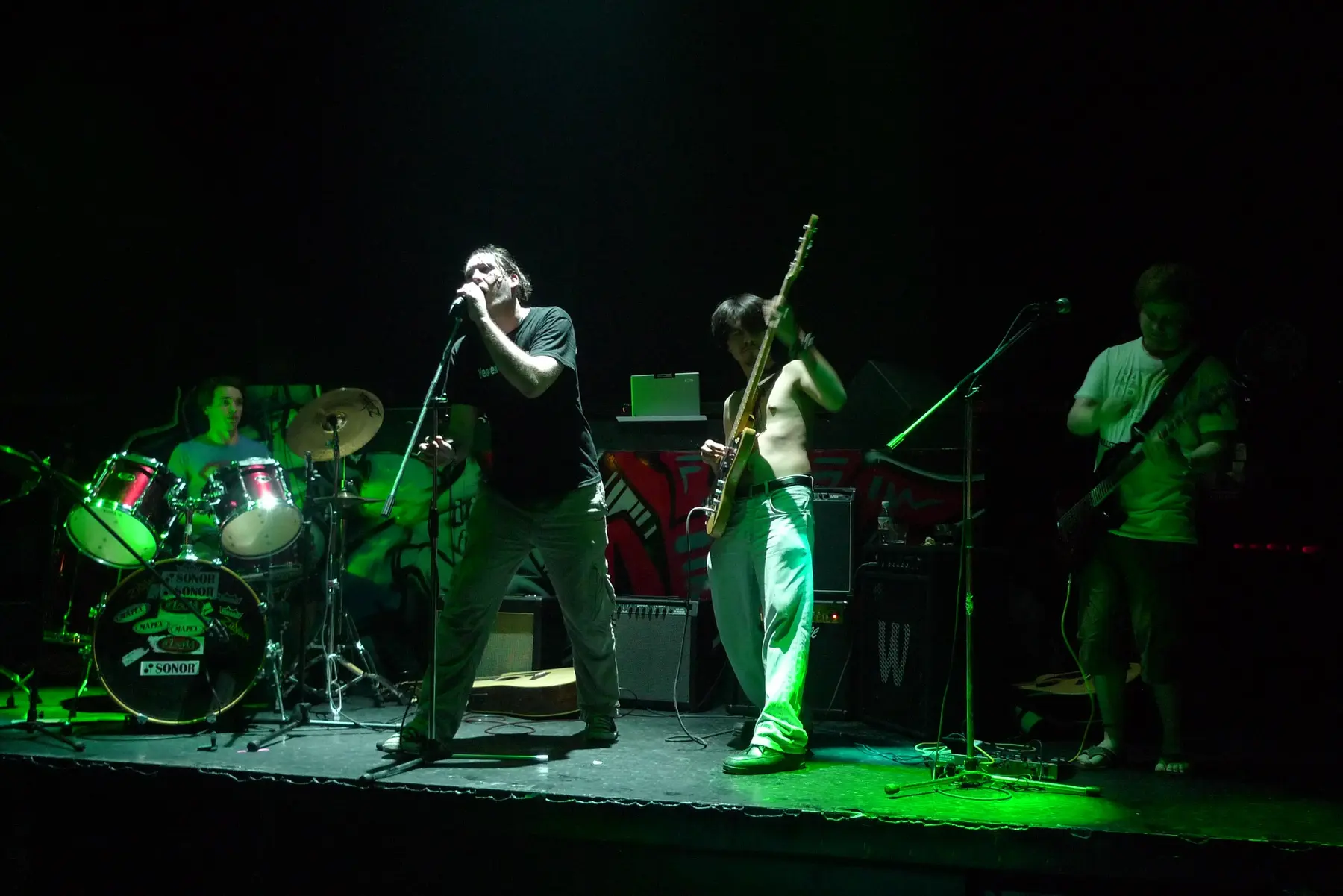 Monroe Stahr performing together under green stage lights
