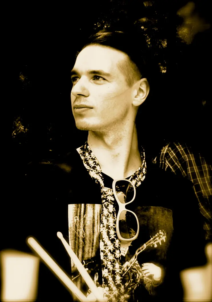 Davide with drumsticks during a Picasso Smiling performance