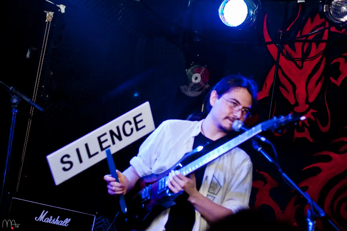 Picasso Smiling live performance with a Silence sign